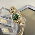 Detail view of horseshoe-shaped gold watch with sunray green dial and chain bracelet - Gold Case Green Dial