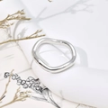 Minimalist wave-shaped stainless steel ring with polished finish on artistic base - US 5 / Thin Wave Ring J306 / Steel