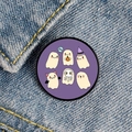 Close-up of cute cartoon ghost pins with BOO text on blue denim fabric background - Purple Background Multiple Ghosts BOO Style (XZ6934)