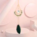 Detailed shot of green agate slice and crystal prism pendant on golden moon wind chime - Green Aventurine