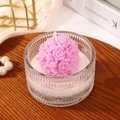 Pink rose shaped scented candle in a textured glass jar on a dark wooden tray - Pink Rose Shape