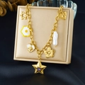 Detail of a gold charm necklace with purple star, flower and pearl on a jewelry box - Purple Gem Star and Baroque Pearl Style (N3784)