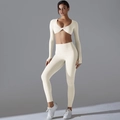 Detail of cream yoga set showing long sleeve crop top with stylish twist-knot neckline - S / Light Ivory