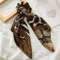 Brown leopard print satin scrunchie with long ribbons on white fabric background - Dark Brown Leopard