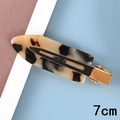 Close-up of a 7cm acetate tortoise shell hair clip with gold metal clamp on a textured surface - 15# Acetate 7cm Beige & Black Tortoiseshell Hair Clip