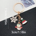 Christmas enamel keychain featuring snowflake and snowman charms in gold finish - ER815-Enamel Snowman Snowflake Christmas Tree Keychain