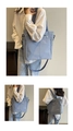 Detail view of light blue nylon tote bag with multiple pockets and adjustable strap - Sky Blue