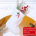 White knitted Christmas stocking with red embroidered letter A and festive holly detail - Letter A