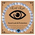 Macro detail of 6mm pink zebra stone beads and blue evil eye charm on a gift card - White Howlite Bracelet