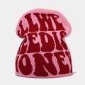 Close-up of pink knit beanie showing red jacquard lettering and soft thick texture - M (56-58cm) / Pink with Red Letters