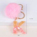 Pink faux fur pom-pom keychain with gold foil letter K resin charm for bag decor - Letter K