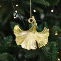 Golden ginkgo leaf Christmas ornament with realistic texture on a festive tree branch - Ginkgo