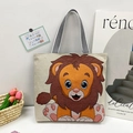 Canvas tote bag with cute cartoon lion print and striped handles in a stylish setting - Style 13 - Chibi Lion (Beige)