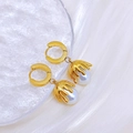 Elegant gold earrings with faux pearl pendants on frosted glass and white fabric - Earrings
