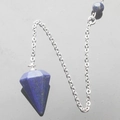 Macro detail of lapis lazuli hexagonal pendulum pendant with stainless steel chain on black surface - Lapis Lazuli