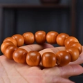 Macro shot of polished Taihang cypress wooden beads showing natural grain and warm brown tones - Thuja Aged Wood Beads 11/12mm