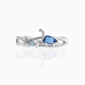 Macro shot of silver dinosaur ring featuring blue zircon and sparkling crystal details - US 7 / Silver Dinosaur (Blue Gem)