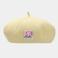 Detail of light yellow knitted beret featuring a colorful floral fabric patch decoration - One Size / Yellow