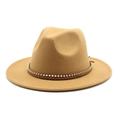 Macro shot of camel wool fedora hat with braided leather strap and metal chain detail - Camel
