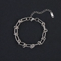 Macro detail of silver stainless steel twisted link bracelet with K18 tag and lobster clasp - Twisted Long Link (CK1654) / Silver