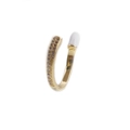 Detailed macro view of the open gold ring with sparkling micro-inlaid zircon and white enamel - White