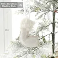White sequined Christmas stocking ornament with plush trim on a snow-covered tree branch - White Small Christmas Stocking