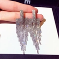 Elegant long silver tassel earrings with shimmering crystals held by hand for display - Silver Layered Long Tassel Rhinestone (251)