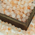 Close-up of orange and white gradient jelly glass beads in a dark wooden box - 10mm / N8# Peach (10MM)