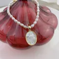 Baroque pearl necklace featuring a golden Virgin Mary pendant with mother of pearl inlay - Style C-Oval Virgin Mary Relief