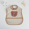 Beige baby waterproof bib with brown trim, pocket, and a cute bear print - Pu Bib (double-layered) - Brown-edged Bear Head / One Size