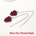 Detail of handmade grape-shaped garnet earrings with silver ear threads and red beads - Silver Ear Threader Pair / Silver