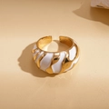 Detail of gold-plated wavy ring with white enamel finish and textured surface - White