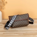 Sac bandoulière vintage marron avec logo et large sangle sur une surface en bois clair - Monogramme Rétro / Monogramme Marron
