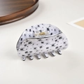 Detail view of large white claw clip with black spider pattern and clear spring - White With Black Spiders / 8.2cm