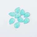 Detailed view of nine teardrop-shaped light blue resin charms with iridescent glitter texture - Light Blue (18)