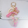 Pink resin letter V keychain with glitter butterflies, gold butterfly and tassel detail - Letter V