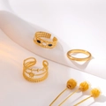 Three gold stainless steel rings with sun motif and blue enamel detail on white stand - J815-Sun Enamel Gold 3-Piece Set