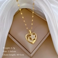 Detail of gold heart pendant with star-moon motif and pavé stones on olive link chain - Gold Star Moon Heart Style (C415)