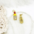 Macro detail of 18K gold plated lipstick charms with colorful enamel and micro zircon - Lipstick