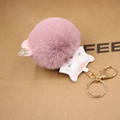 Detailed view of pink plush fox keychain with PU leather head and golden metal ring - Dust Rose