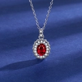 Silver necklace featuring an oval red gemstone pendant with halo of white zircons - Red Diamond Necklace Tz-10