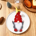 Festive gnome cutlery holder set on a white plate with golden fork and knife detail - Faceless Gnome Cutlery Set A