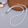Detail of white woven phone lanyard with metal clasp and clear patch on grey surface - White