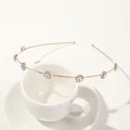 Detail showing gold leaf headband with sparkling rhinestones on a white ceramic cup - Metal Headband-Plum Gold White Zirconia