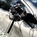 Close-up of a large black sequin mesh bow tied on a silver car rearview mirror for decor - 10 Strands Pack / Pastel Black