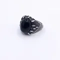 Detailed macro view of vintage titanium steel ring with oval black gemstone and textured band - US 8 / Style A