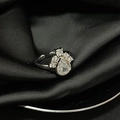 Macro shot of silver adjustable eye-shaped ring with teardrop zircons on black silk - Adjustable Open / Silver Pear Round Diamond