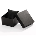 Detail of an open black textured gift box with a matching watch pillow on white background - Black Textured Paper Square Single Box