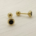 Macro shot of gold-tone titanium steel dumbbell stud with black cubic zirconia stone - Gold/Black