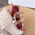 Women's watch with burgundy leather strap and gold polygonal case on female wrist - Bracelet Style Leather Chain